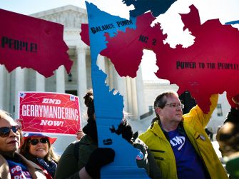 Protesters holding signs against gerrymandering outside the U.S. Supreme Court.