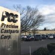 Signage for Precision Castparts Corp. with the company's facility and parking lot visible in the background. Signage for Precision Castparts Corp. with the company's facility and parking lot visible in the background.