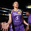 Dearica Hamby, wearing a Los Angeles Sparks jersey, is seen during a game, interacting with fans and teammates. Dearica Hamby, wearing a Los Angeles Sparks jersey, is seen during a game, interacting with fans and teammates.