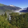 Scenic view of the Tongass National Forest, showcasing lush greenery, a river, and distant mountains with a glacier. Scenic view of the Tongass National Forest, showcasing lush greenery, a river, and distant mountains with a glacier.
