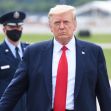 Donald Trump walking away from a vehicle, with an Air Force officer in the background. Donald Trump walking away from a vehicle, with an Air Force officer in the background.