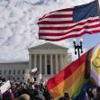 A crowd gathers outside the Supreme Court building, with American and pride flags visible, as oral arguments are presented regarding Tennessee's transgender law. A crowd gathers outside the Supreme Court building, with American and pride flags visible, as oral arguments are presented regarding Tennessee's transgender law.