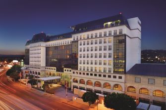 Exterior view of the Sofitel Hotel in Beverly Hills, California, at dusk.