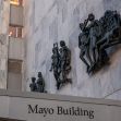 Facade of the Mayo Building with sculptures depicting various figures. Facade of the Mayo Building with sculptures depicting various figures.