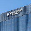 Signage of Liberty Mutual Insurance on the exterior of a modern building. Signage of Liberty Mutual Insurance on the exterior of a modern building.