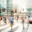 A busy urban crosswalk with blurred pedestrian traffic and a car approaching, highlighting various movement in the scene. A busy urban crosswalk with blurred pedestrian traffic and a car approaching, highlighting various movement in the scene.