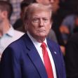 Former President Donald Trump at a public event, amidst a crowded background. Former President Donald Trump at a public event, amidst a crowded background.