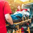 An emergency medical team transporting a patient on a stretcher into an ambulance. An emergency medical team transporting a patient on a stretcher into an ambulance.