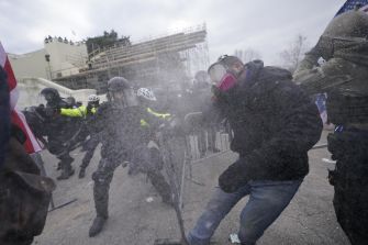 Clashes between law enforcement and protesters during the January 6 Capitol riot, highlighting the chaos and violence of the day.