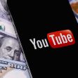 YouTube logo displayed on a smartphone with U.S. dollar bills in the background. YouTube logo displayed on a smartphone with U.S. dollar bills in the background.