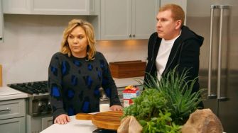 Todd and Julie Chrisley from the reality series "Chrisley Knows Best" looking concerned while standing in their kitchen.
