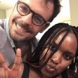 A man and a woman posing together for a selfie, both smiling, with the woman making a peace sign gesture. A man and a woman posing together for a selfie, both smiling, with the woman making a peace sign gesture.