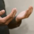 A pair of hands in a prayer posture, reflecting a moment of devotion and spirituality. A pair of hands in a prayer posture, reflecting a moment of devotion and spirituality.