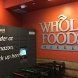 Amazon locker station at a Whole Foods Market, with signage indicating ordering and pickup options. Amazon locker station at a Whole Foods Market, with signage indicating ordering and pickup options.
