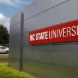Signage of North Carolina State University (NC State) along a roadside. Signage of North Carolina State University (NC State) along a roadside.