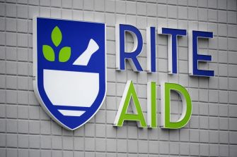 Rite Aid store sign on a brick wall.