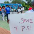 A man holds a sign reading "SAVE TPS!" at a rally advocating for the continuation of Temporary Protected Status for Haitian immigrants, while other supporters gather in the background. A man holds a sign reading "SAVE TPS!" at a rally advocating for the continuation of Temporary Protected Status for Haitian immigrants, while other supporters gather in the background.