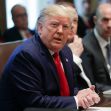 Donald Trump seated at a meeting table, addressing attendees. Donald Trump seated at a meeting table, addressing attendees.