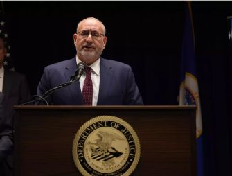 U.S. Attorney Andrew Luger speaking at a press conference about charges related to a massive pandemic relief fraud case.