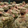 A group of military personnel in uniform saluting, highlighting the importance of honor and recognition in the armed forces. A group of military personnel in uniform saluting, highlighting the importance of honor and recognition in the armed forces.
