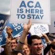 A diverse group of people holding signs reading "ACA IS HERE TO STAY" in support of the Affordable Care Act. A diverse group of people holding signs reading "ACA IS HERE TO STAY" in support of the Affordable Care Act.
