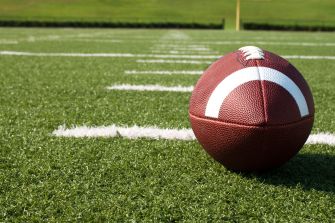 A football on a field, symbolizing a high school football game where a shooting incident occurred.