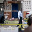 Law enforcement officials work the scene of a shooting outside a banquet hall near Hialeah, Fla.