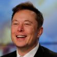 Image of a man smiling in a suit, with a blurred background. Image of a man smiling in a suit, with a blurred background.
