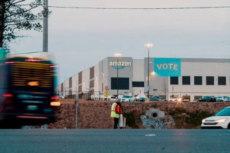 Amazon fulfillment center in Bessemer, Alabama, with a "VOTE" banner visible on the building during a unionization vote.