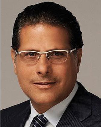Portrait of a man in a suit with glasses, involved in a financial fraud case.