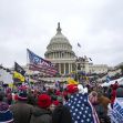 Crowd gathered at the U.S. Capitol during the January 6th riot, with flags and signs visible. Crowd gathered at the U.S. Capitol during the January 6th riot, with flags and signs visible.