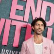 Actor posing at the premiere of the film "It Ends With Us," featuring a pink backdrop with the movie's title. Actor posing at the premiere of the film "It Ends With Us," featuring a pink backdrop with the movie's title.