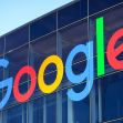 The Google logo displayed prominently on a building. The Google logo displayed prominently on a building.