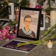 A memorial display for Justice Ruth Bader Ginsburg, featuring a framed portrait, flowers, and candles, with a quote reflecting her wish for a new president before her replacement. A memorial display for Justice Ruth Bader Ginsburg, featuring a framed portrait, flowers, and candles, with a quote reflecting her wish for a new president before her replacement.