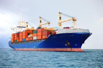 Cargo ship loaded with containers at sea.