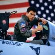 A pilot giving a thumbs-up in the cockpit of a fighter jet with an American flag in the background. A pilot giving a thumbs-up in the cockpit of a fighter jet with an American flag in the background.