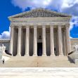 Exterior view of the United States Supreme Court building with a clear blue sky and clouds. Exterior view of the United States Supreme Court building with a clear blue sky and clouds.