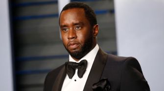 Sean Combs posing in formal attire at an event.