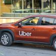 An Uber vehicle parked on the street, highlighting the company's branding. An Uber vehicle parked on the street, highlighting the company's branding.