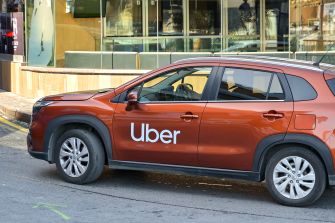 An Uber vehicle parked on the street, highlighting the company's branding.