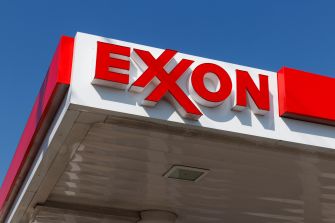 Exxon gas station sign against a clear blue sky.