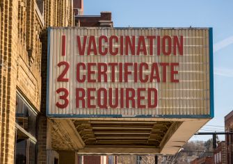 Signboard displaying text: "1. VACCINATION 2. CERTIFICATE 3. REQUIRED."
