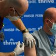 Joe Pumo, RN, left, administers the Moderna COVID-19 vaccination to Dr. Scott Andersen, right, a neuroradiologist, at Kaiser Permanente Lone Tree Medical Offices on December 23, 2020 in Lone Tree, Colorado.