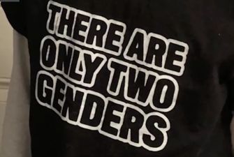 A close-up of a black t-shirt featuring the text "THERE ARE ONLY TWO GENDERS" in bold white letters.