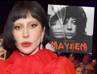 Close-up of a person with short black hair and bold makeup, wearing a red outfit, alongside the album cover of "MAYHEM" featuring a black-and-white image with stylized text.