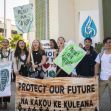 A group of young people holding signs and banners advocating for climate action and environmental preservation. A group of young people holding signs and banners advocating for climate action and environmental preservation.