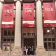 Students outside Harvard Law School during orientation, with banners showcasing the school. Students outside Harvard Law School during orientation, with banners showcasing the school.