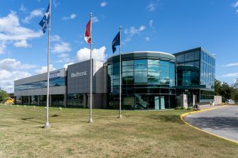 Exterior view of Medtronic's building with flags in front.