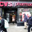 Image of a CVS pharmacy storefront with people walking by. Image of a CVS pharmacy storefront with people walking by.