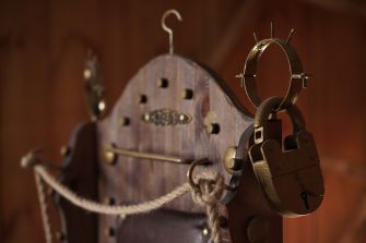 An old torture device with locks and ropes, symbolizing themes of violence and human rights violations.